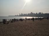Families gather before sunset on Chowpatty beach in Mumbai