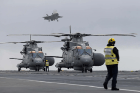 Merlin helicopters and F-35B fighter jets have landed on HMS Prince of Wales ahead of the Royal Navy flagship's global deployment to the Indo-Pacific region.