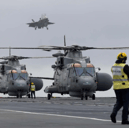 Merlin helicopters and F-35B fighter jets have landed on HMS Prince of Wales ahead of the Royal Navy flagship's global deployment to the Indo-Pacific region.