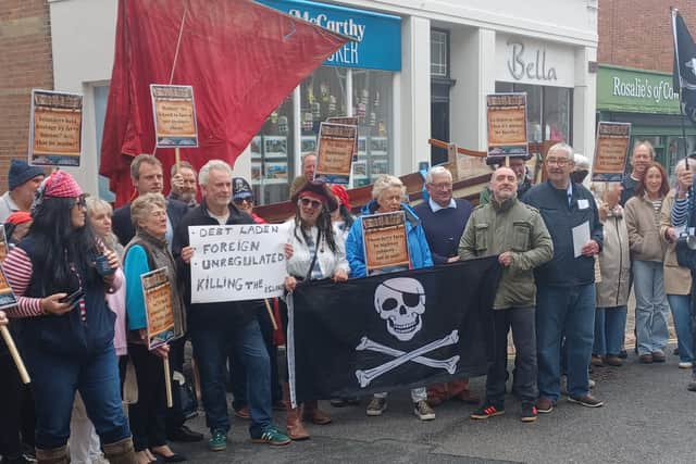Protesters in Cowes High Street wearing pirate outfits and placards over unreliable and expensive ferry services to the Isle of Wight - including from Portsmouth