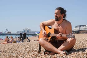 Hot weather pictures in Southsea, Portsmouth 

Pictured: Ian Jemison on the beach playing his guitar

Picture: Jack Oliver