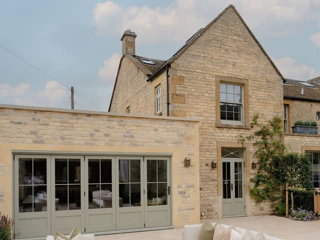 The exterior is a classic Cotswolds house, made from the local stone