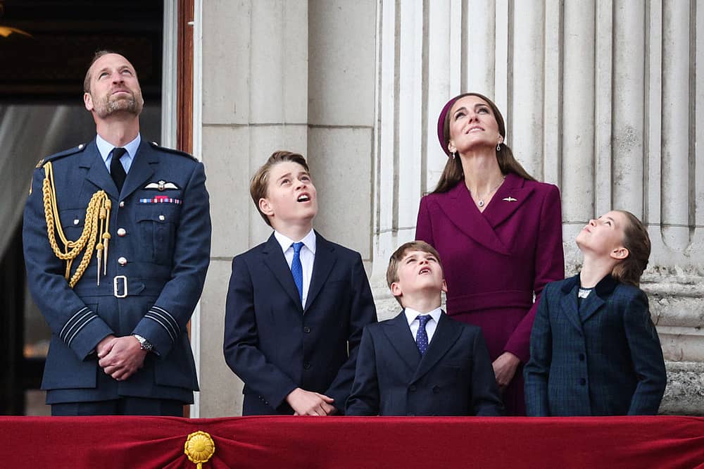 Prince William, Prince of Wales, Prince George of Wales, Prince Louis of Wales, Catherine, Princess of Wales and Princess Charlotte of Wales watch the Red Arrows flypast from Buckingham Palace.