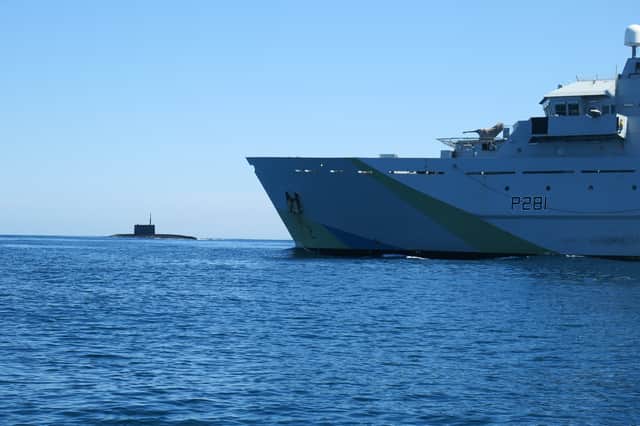 HMS Tyne with Russian Kilo-class submarine Krasnodar in the background.