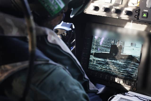 An observer from 815 Naval Air Squadron tracks a Russian Kilo Class Submarine Krasnodar from a wildcat helicopter from the UK Carrier Strike Group during Operation Highmast 2025.