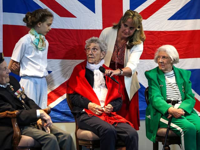 The Portsmouth Historic Dockyard hosted a VE day event  where veterans were interviewed about their wartime memories. 

Pictured: Charlotte, 12, asking a question. 
From left, Robin Boodle who was an able seaman in the Battle of The Atlantic, Mabel Kidney of the WRNS and Dorothy Walsh who worked at Bletchley Park with Alan Turing on the Enigma machine. 

Picture: Chris Moorhouse (100525-33)