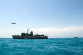 Portsmouth-based Royal Navy minehunter HMS Middleton joined forces with American, Kuwaiti and Iraqi forces to conduct a rescue exercise in the Gulf. Picture: A Kuwaiti police helicopter flies past HMS Middleton