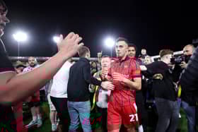 Walsall fans celebrate their League Two play-off semi-final victory over Chesterfield on the pitch at the Bescot Stadium