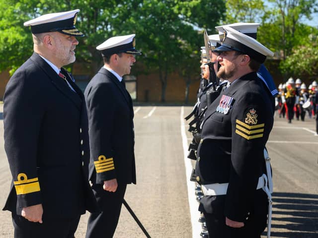 The Royal Navy Rear Admiral inspecting the guard at HMS Collingwood in Fareham during a visit.