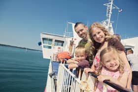 Kids Go Free - Family outside on board Wightlink Ferry in summer