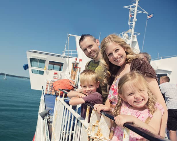 Kids Go Free - Family outside on board Wightlink Ferry in summer