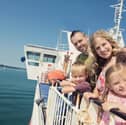 Kids Go Free - Family outside on board Wightlink Ferry in summer