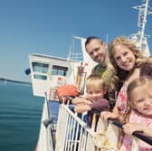 Kids Go Free - Family outside on board Wightlink Ferry in summer