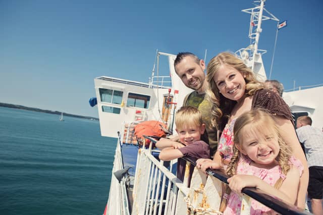 Kids Go Free - Family outside on board Wightlink Ferry in summer