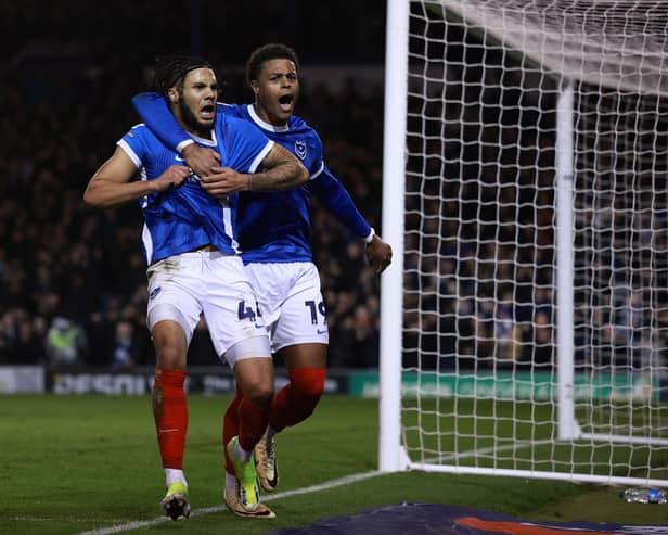 Former Pompey midfielder Myles Peart-Harris, left, celebrates scoring against Cambridge United with former Fratton Park team-mate Kusini Yengi