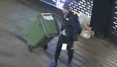 Reece Wheat drags the wheelie bin of stolen goods.