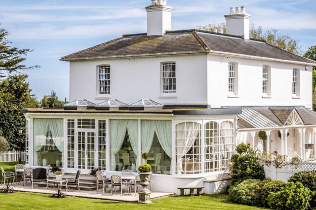 Merston House blends timeless Regency architecture with modern country living, complete with an orangery and sun-soaked patio for entertaining.