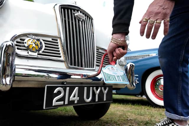 Dennis Jackson turns his 'crank handle' to start the engine on his 1958 Wolesley 1500 classic car Photo Credit: Lucinda Herbert