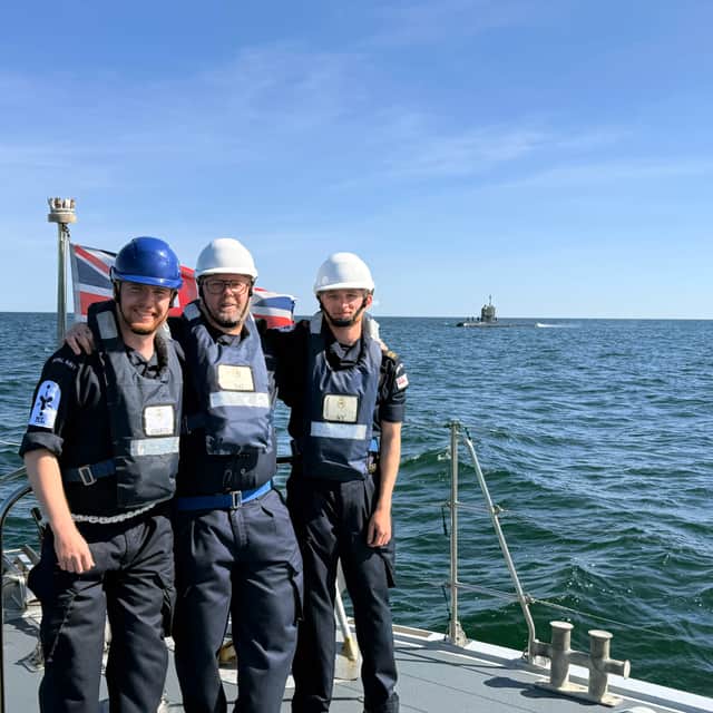 Crew of the HMS Dasher celebrate a successful transfer of coffee to the Swedish submariners.