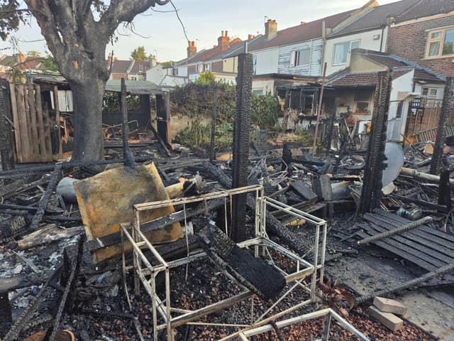 Two boys have been arrested on suspicion of arson after a large fire erupted from a tree and destroyed several garages.