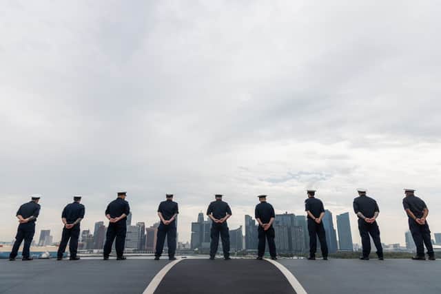 Royal Navy sailors on HMS Prince of Wales as it sails into Singapore.