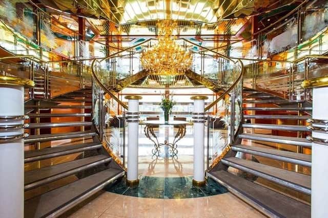 Inside the Sunborn: the grand staircase and chandelier set the tone for a stay that feels more Monaco than London.