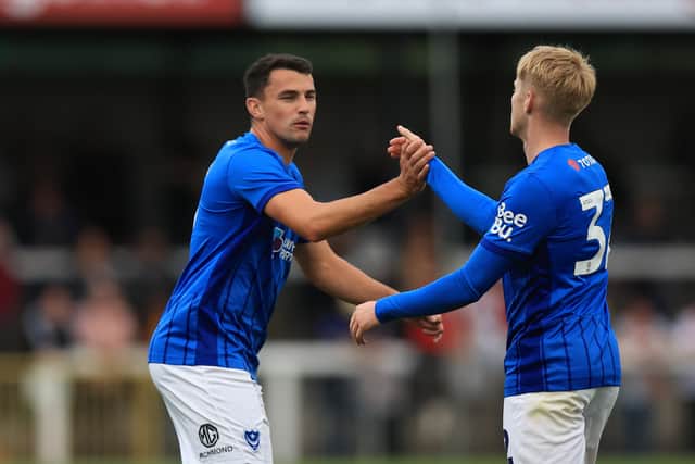 Regan Poole celebrates Paddy Lane's Pompey goal at Woking last night. Pic: Simon Roe/ProSportsImages