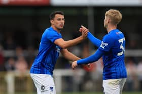 Regan Poole celebrates Paddy Lane's Pompey goal at Woking last night. Pic: Simon Roe/ProSportsImages