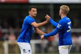Regan Poole celebrates Paddy Lane's Pompey goal at Woking last night. Pic: Simon Roe/ProSportsImages