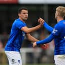 Regan Poole celebrates Paddy Lane's Pompey goal at Woking last night. Pic: Simon Roe/ProSportsImages