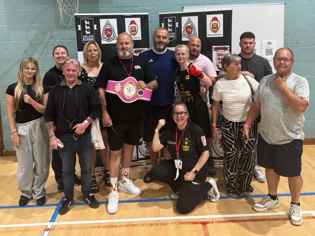 Poppy Cooper with her Leigh Park coaches and famil after  Ringside Trust Box Cup victory.