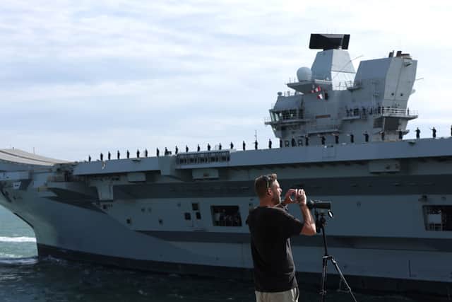 HMS Queen Elizabeth passes the Round Tower as she leaves HMNB Portsmouth.