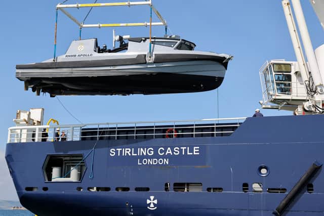Pictured here: RFA Stirling Castle hoisting RNMB Apollo . RFA Stirling Castle, a mine-hunting mothership, proved her ability to work with autonomous and un-crewed boats during a series of trials in Portland.