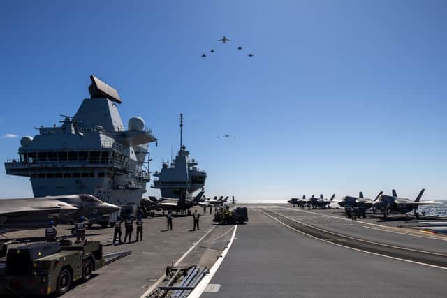 Australian E-7, USMC F-35B, UK F-35B, two Australian F/A-18F, two Australian F-35A, RC-135 and a Australian EA-18G fly in formation over HMS Prince of Wales.