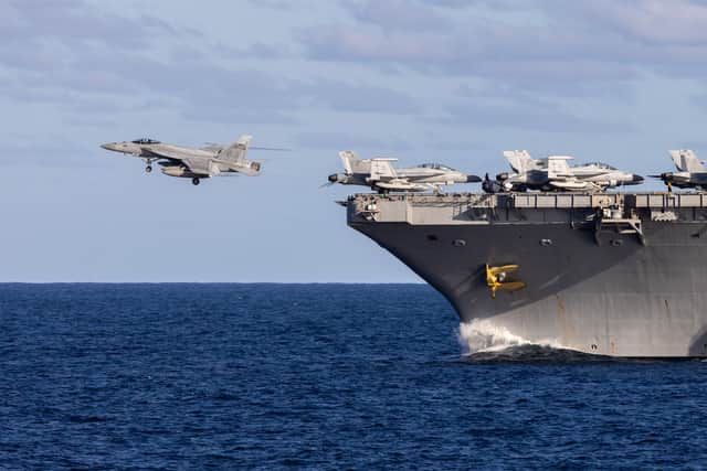 US F/18 launches from US Aircraft Carrier, USS George Washington as it sails alongside HMS Prince of Wales as the UK Carrier Strike Group integrates with US Navy forces during Exercise TALISMAN SABRE 25.