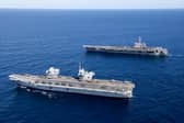 HMS Prince of Wales completed Exercise Talisman Sabre off the coast of Australia with her carrier strike group, joining forces with American sailors. Pictured Top to Bottom: United States Aircraft Carrier, USS George Washington and UK Aircraft Carrier, HMS Prince of Wales.