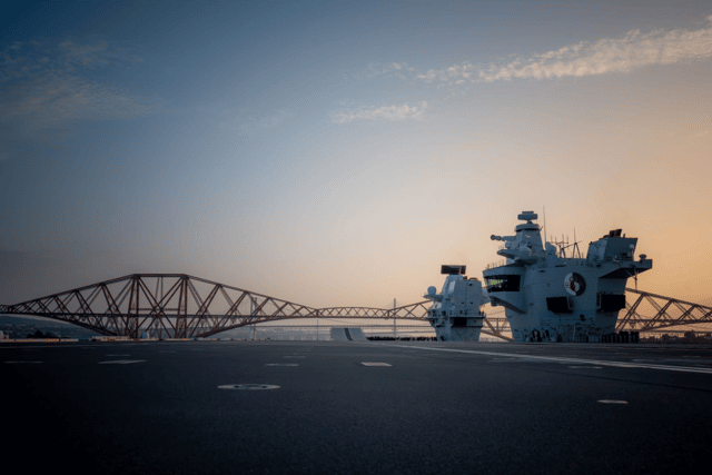 HMS Queen Elizabeth sailing under the Forth Bridges in Scotland as she reaches the final leg of her journey to Rosyth. She left Portsmouth for the second half of her maintenance period, with mechanical "issues" being discovered on the ship.