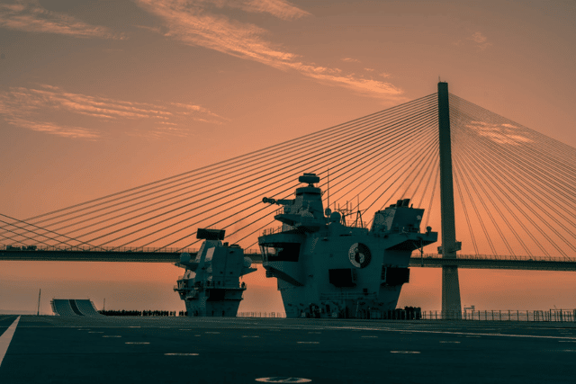 HMS Queen Elizabeth sailing under the Forth Bridges in Scotland as she reaches the final leg of her journey to Rosyth. She left Portsmouth for the second half of her maintenance period, with mechanical "issues" being discovered on the ship.