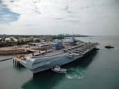 A historic defence trade agreement has been signed between the UK and Australia worth up to £20bn, in the backdrop of HMS Prince of Wales becoming the first Royal Navy carrier to visit Darwin this century.