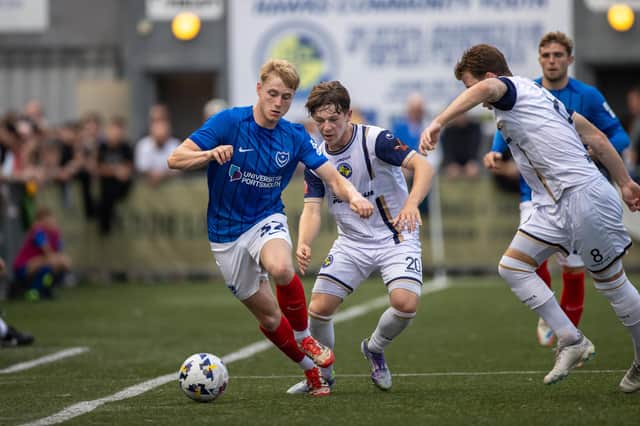 The Hawks' Harvey Laidlaw puts Paddy Lane under pressure in Tuesday night's goalless draw against Pompey. Picture: Alex Shute