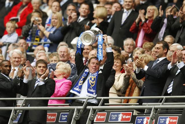 Harry Redknapp (C) lifts the the F.A Cup after winning the final against Cardiff City at Wembley Stadium in London on May 17, 2008. Portsmouth won the game 1-0 with a goal from Kanu.