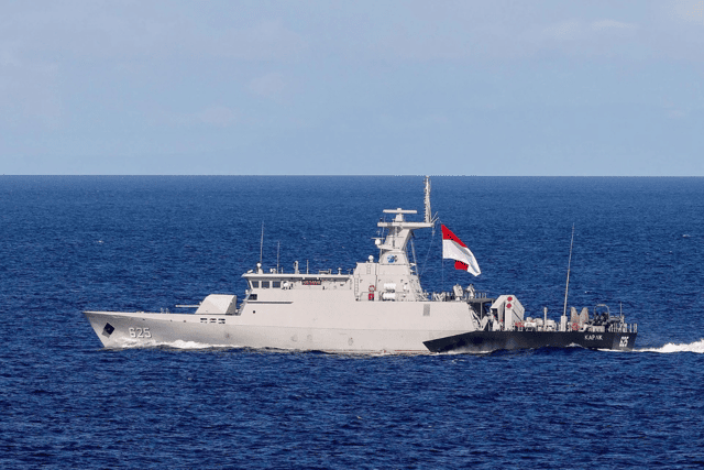 Indonesian warship KRI Karpak sailing past HMS Prince of Wales.