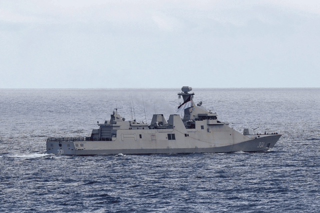 Indonesian warship KRI Raden Eddy Martadinata sailing past HMS Prince of Wales.