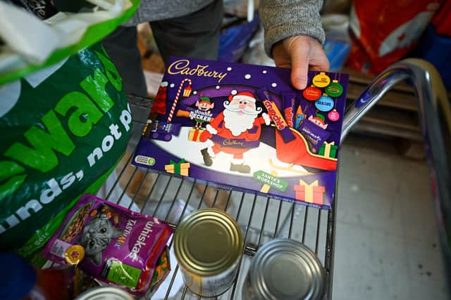 A Christmas chocolate selection box is unpacked in Weymouth Foodbank distribution hub in December 2023 (Photo: Finnbarr Webster/Getty Images)