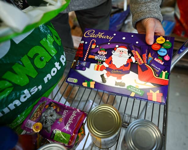 A Christmas chocolate selection box is unpacked in Weymouth Foodbank distribution hub in December 2023 (Photo: Finnbarr Webster/Getty Images)