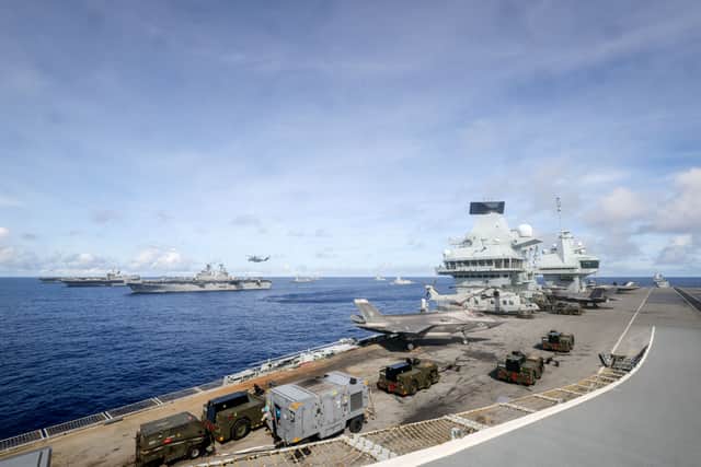 HMS Prince of Wales sailing in formation with (left to right) USS George Washington, JS Kaga Teruzuki, USS America, USS Shoup, JS Teruzuki, USS Robert Smalls, ESP Mendez Nunez with HMS Richmond, and HMS Dauntless aft of the carrier. The Royal Navy flagship has arrived in Japan after completing major exercises with international forces.