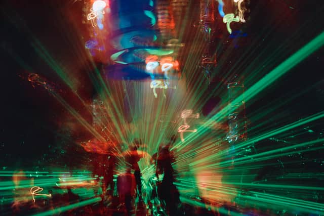 People reaching for the lasers at Amnesia in Ibiza back in 2000 - one of the few superclubs on the island that led to a huge surge in tourism from clubbers.