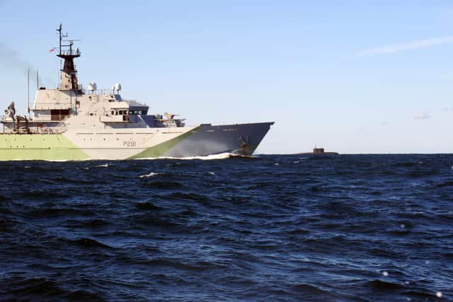 HMS Tyne, a Royal Navy ship based in Portsmouth, has been sent to Scotland while conducting officer training on board. Pictured is the vessel keeping tabs on a surfaced Kilo-class submarine in the Channel.