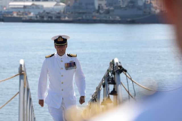 Cdr Skinner proceeding onboard HMS Dauntless.