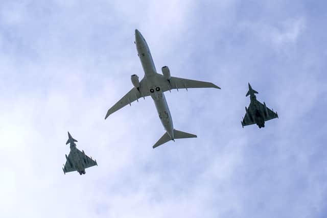 British pilots were scrambled to look for a Russian submarine after it was spotted near the American carrier USS Geralrd R Ford. Pictured: Two Tornados and a Poseidon aircraft (C) perform a fly-past as Britain's King Charles III visits RAF (Royal Air Force) Lossiemouth in Moray.